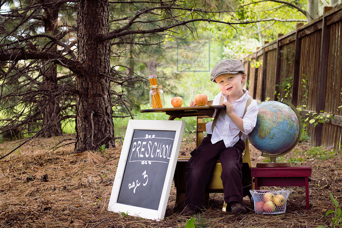 Child at desk with back-to-school photo props
