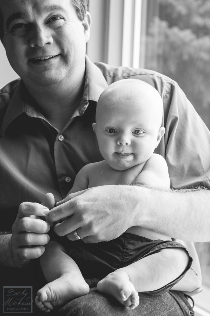 black and white photo of baby with dad