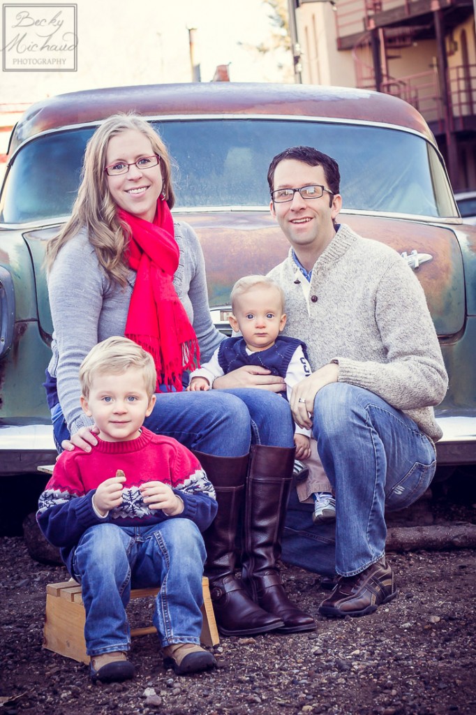 family portrait by an antique car