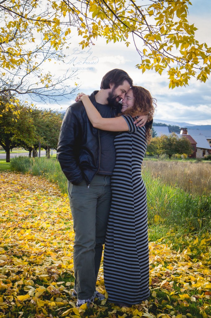 A couple hugging in the fall leaves