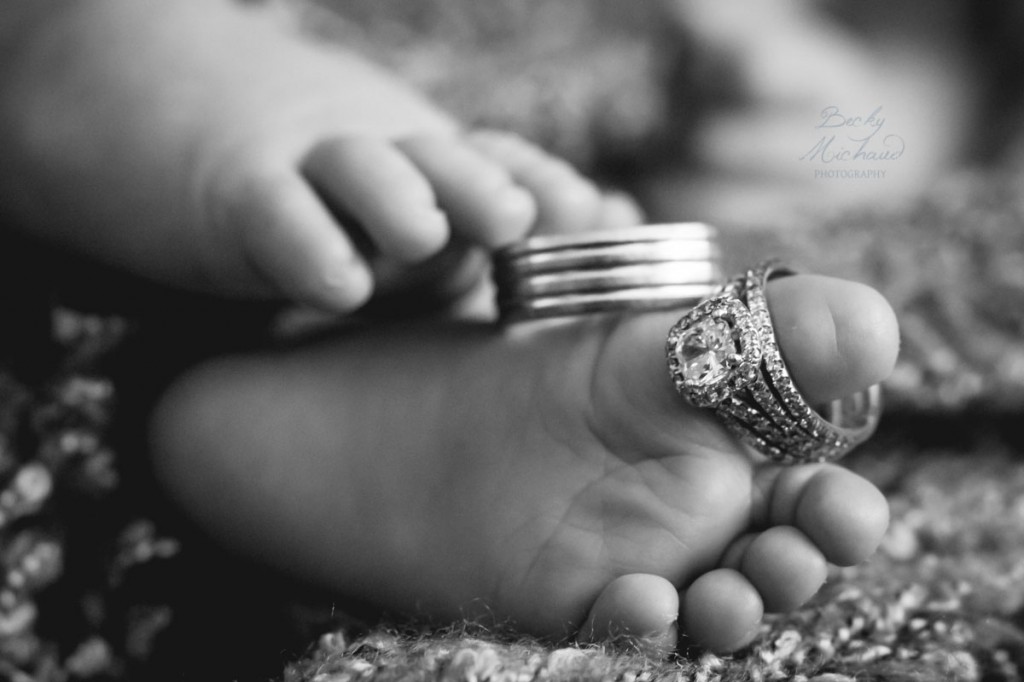 baby's toes with mom and dad's wedding rings on them