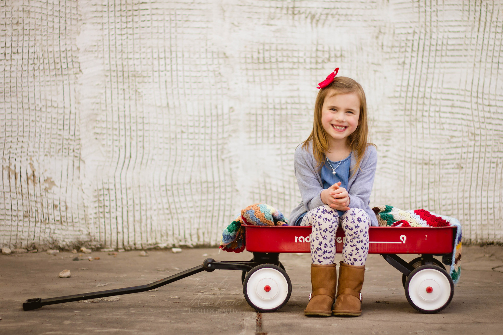 little girl in a red wagon