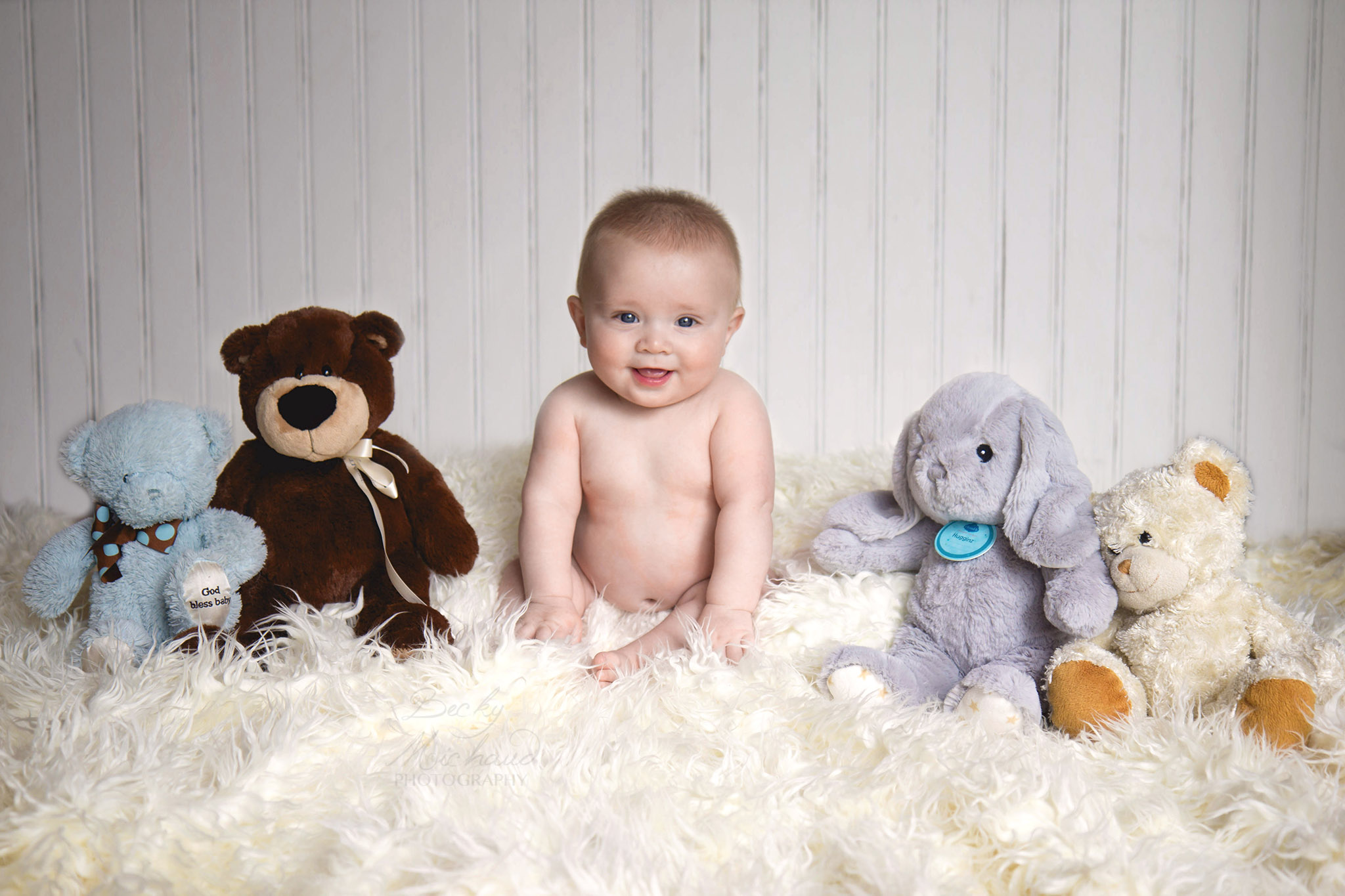 Infant with stuffed animals