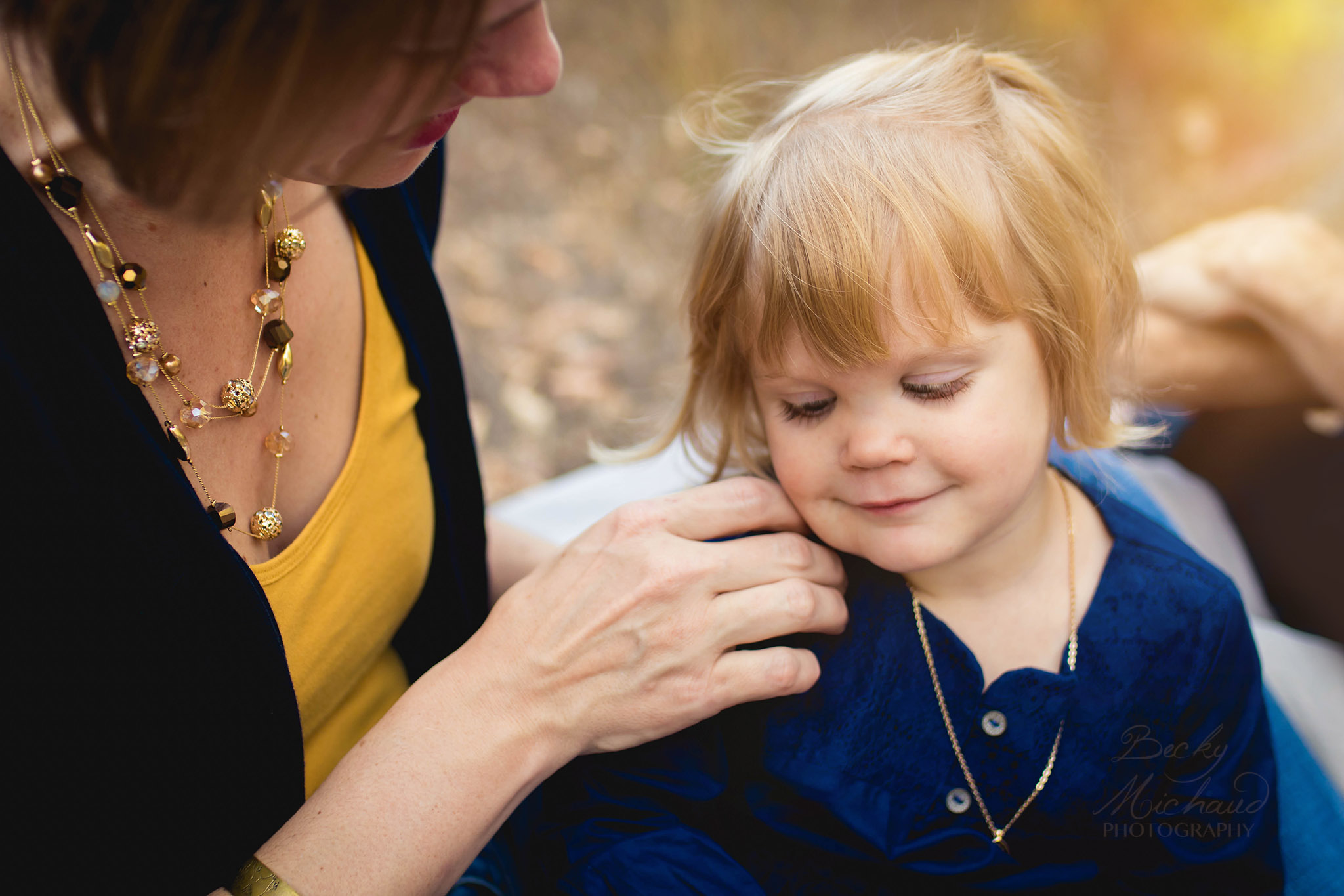photo of a mother touching her daughter's cheek  taken by a Fort COllins family photographer