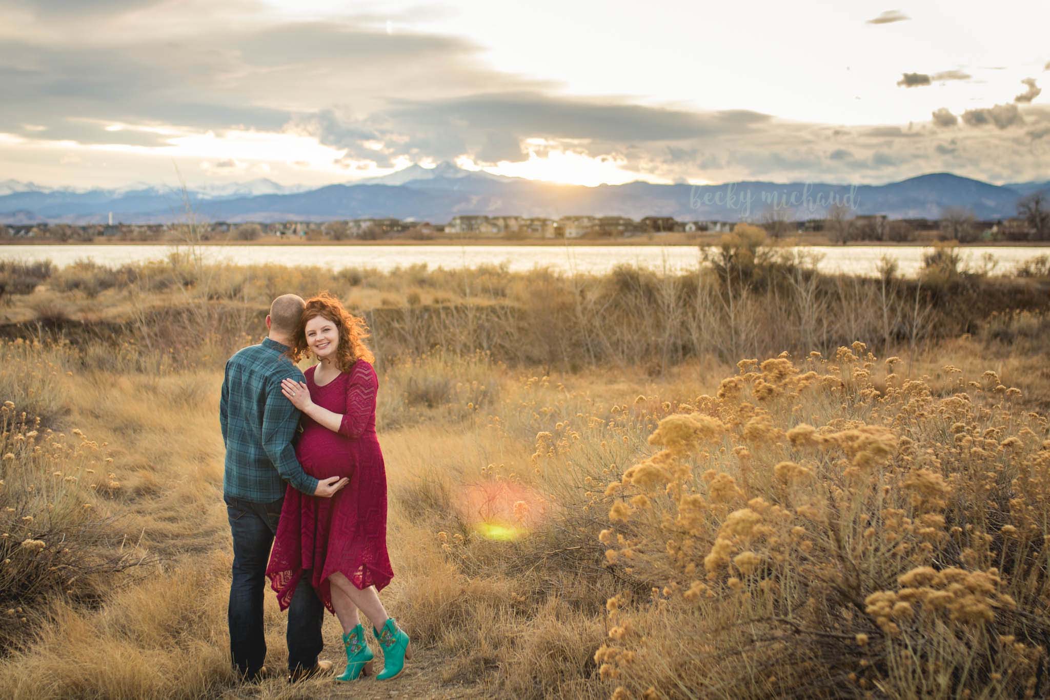 Maternity photo of a couple in front of the Colorado mountains at sunset