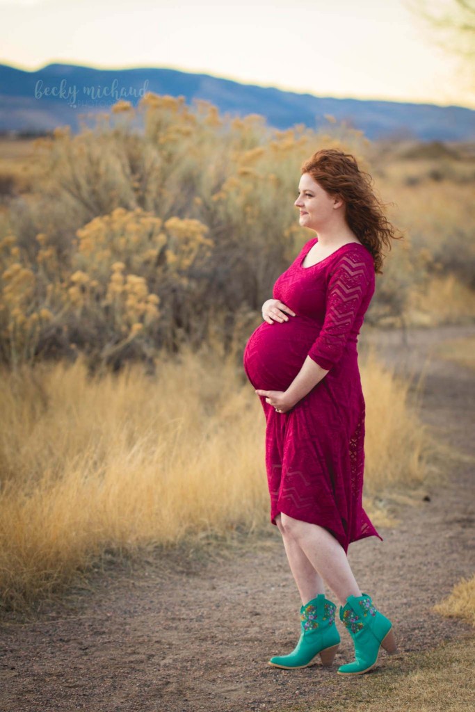 A pregnant mother looks out onto the mountains in Colorado