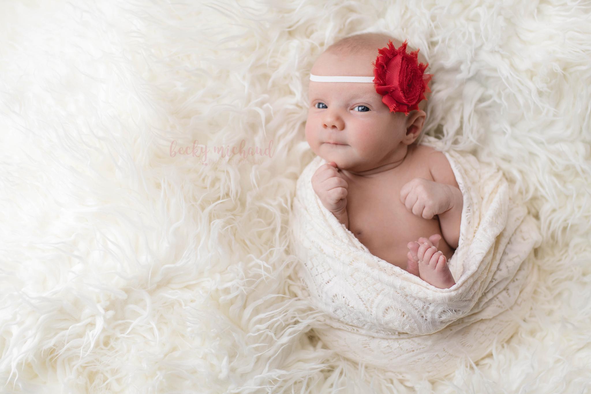 newborn baby girl with red flower headband