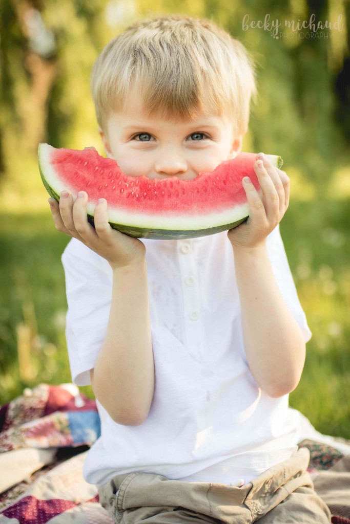 little boy smiling with a giant slice of watermelon