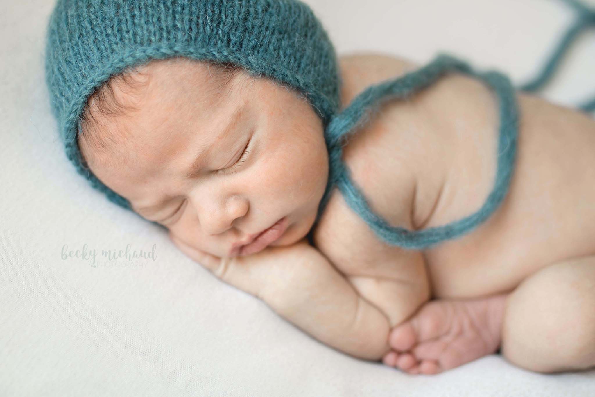 sweet and simple photo of a newborn boy wearing a blue hat