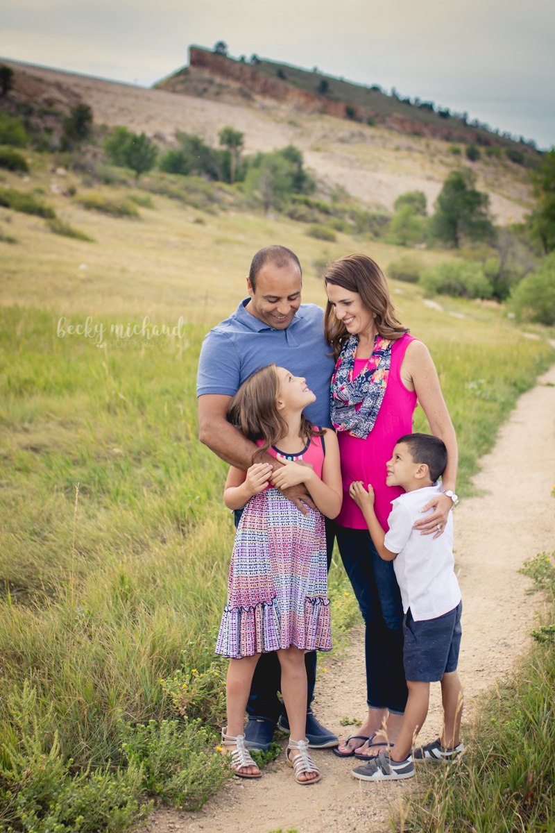 A family stands together on a path at Pineridge Natural Area in Fort Collins