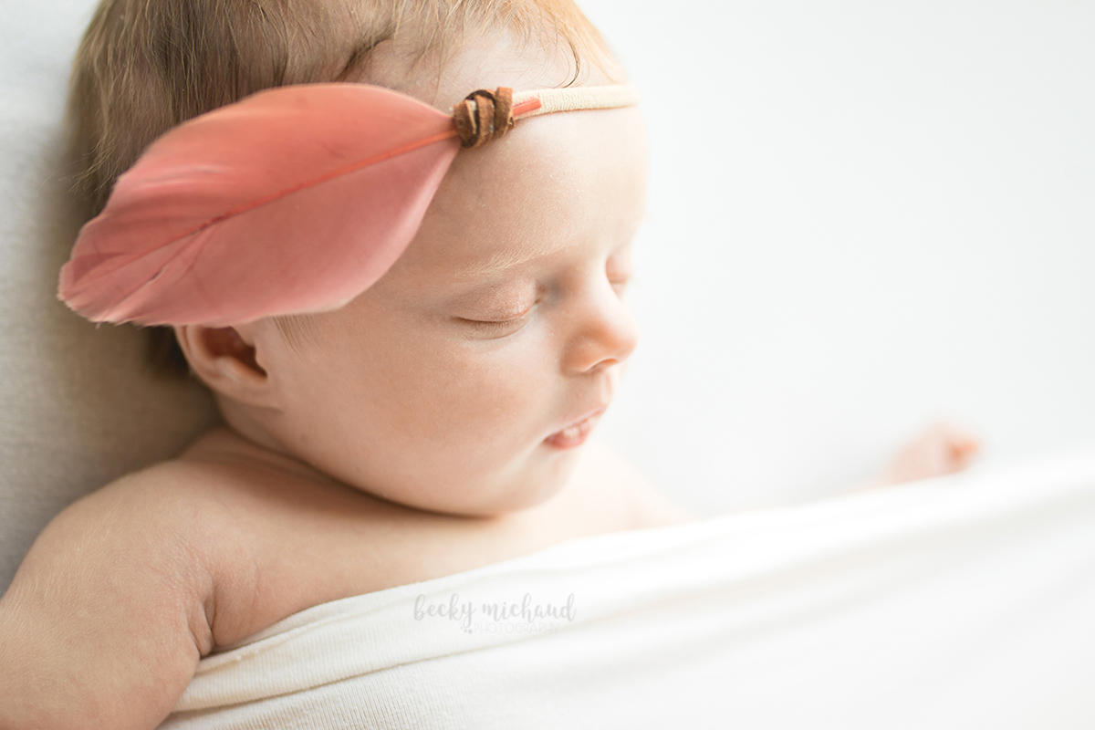 silhouette of a baby girl with a pink feather boho headband