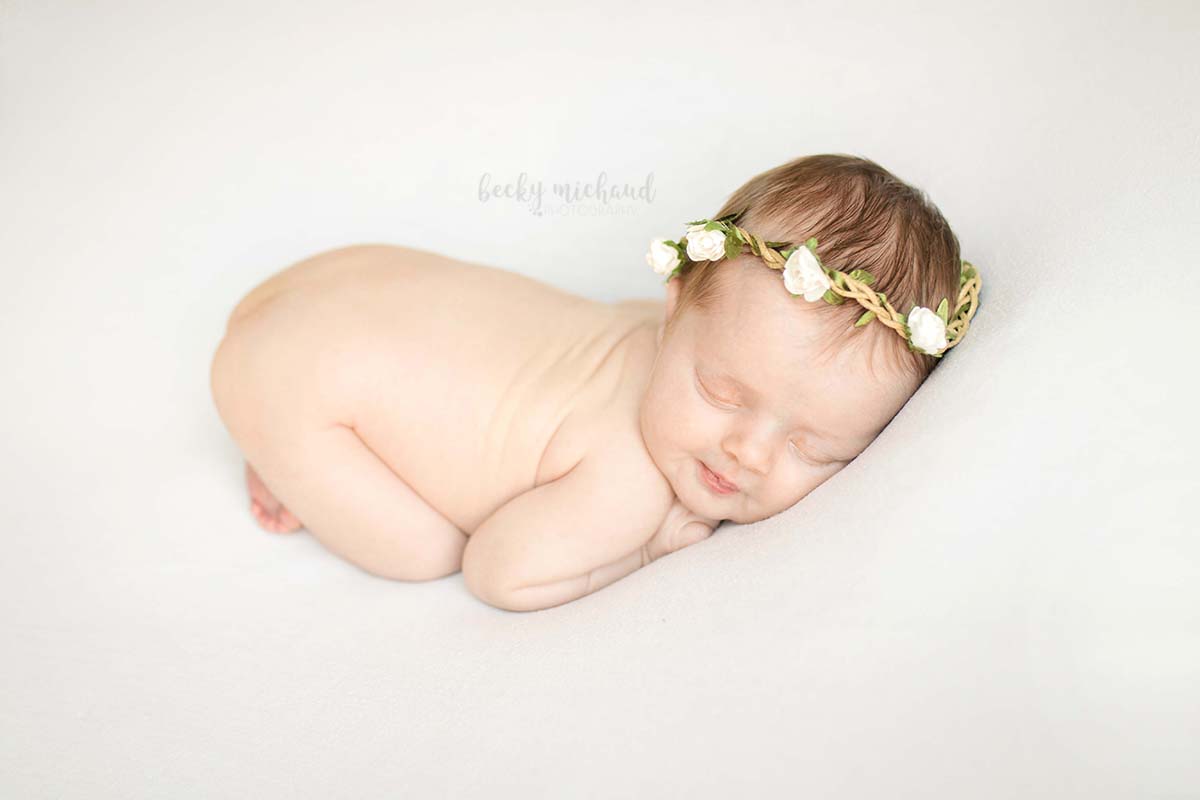 A baby girl poses for her newborn photo session