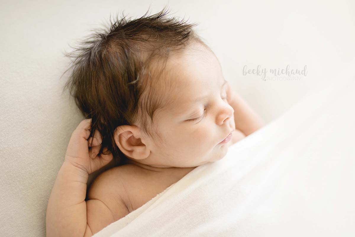 backlit photo of the profile of a newborn baby boy taken by Becky Michaud, Fort Collins newborn photographer