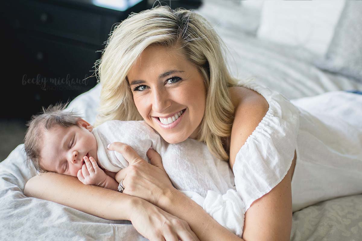 A mom poses with her newborn for her lifestyle photo session by Becky Michaud, Fort Collins photographer