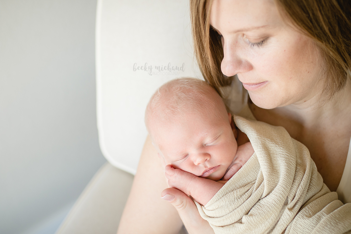 Becky Michaud, Fort Collins photographer, captures a mom looking at her baby during their newborn lifestyle photo session