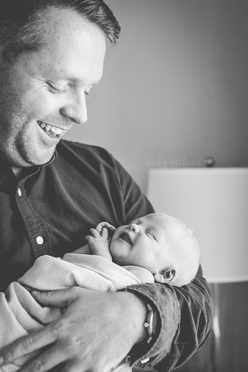 black and white photo of a Fort Collins dad smiling at his baby girl