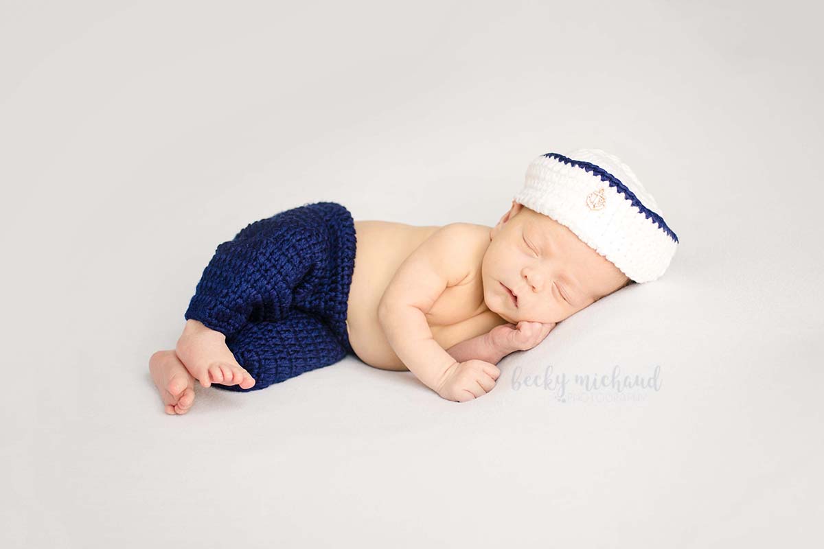 newborn baby wearing a sailor suit