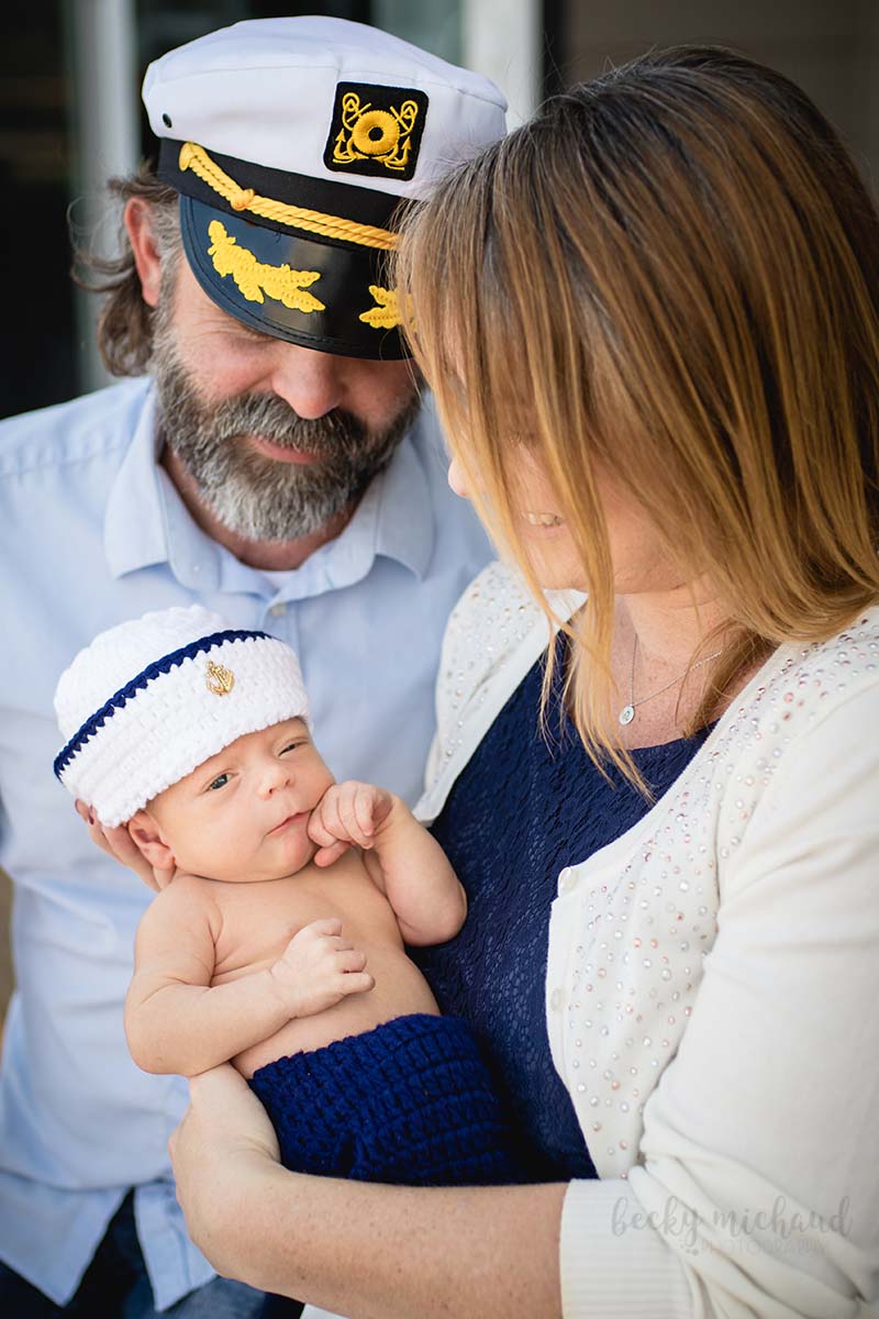 nautical themed family photo with a newobrn