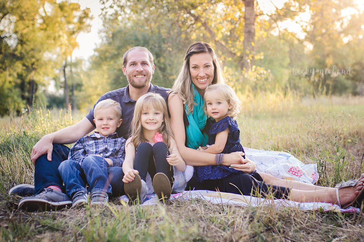 A family poses at Legacy Park for their fall portrait session