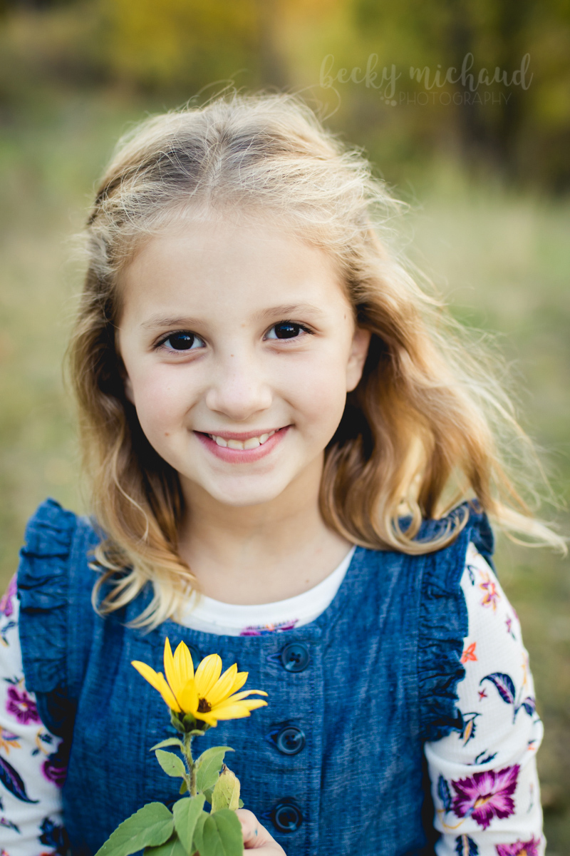 Portrait of a young girl holding a yellow flower by Becky Michaud, Fort Collins photographers