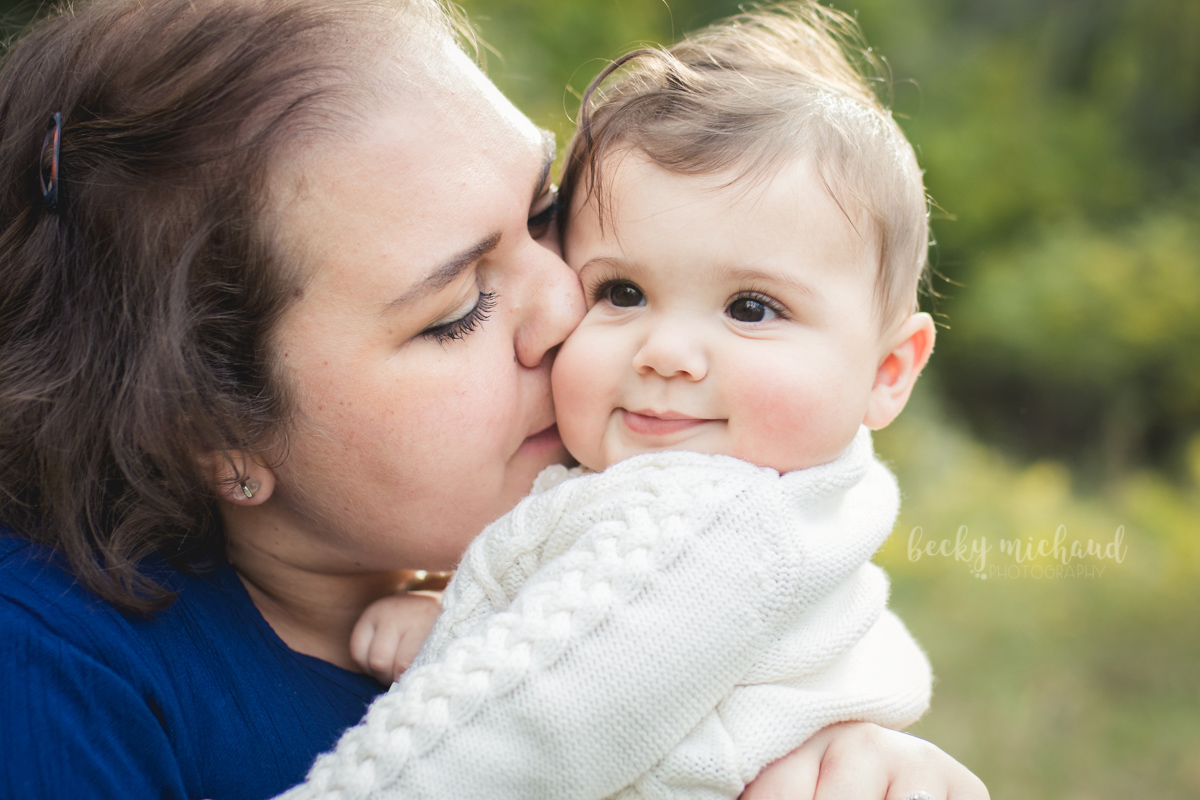 Mom gives kisses to her sweet baby girl during their photo shoot with Becky Michaud, Fort Collins photographer