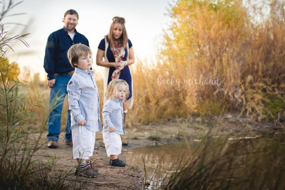 A family of four plays by the pond at Arapahoe Bend Natural Area in southern Fort Collins