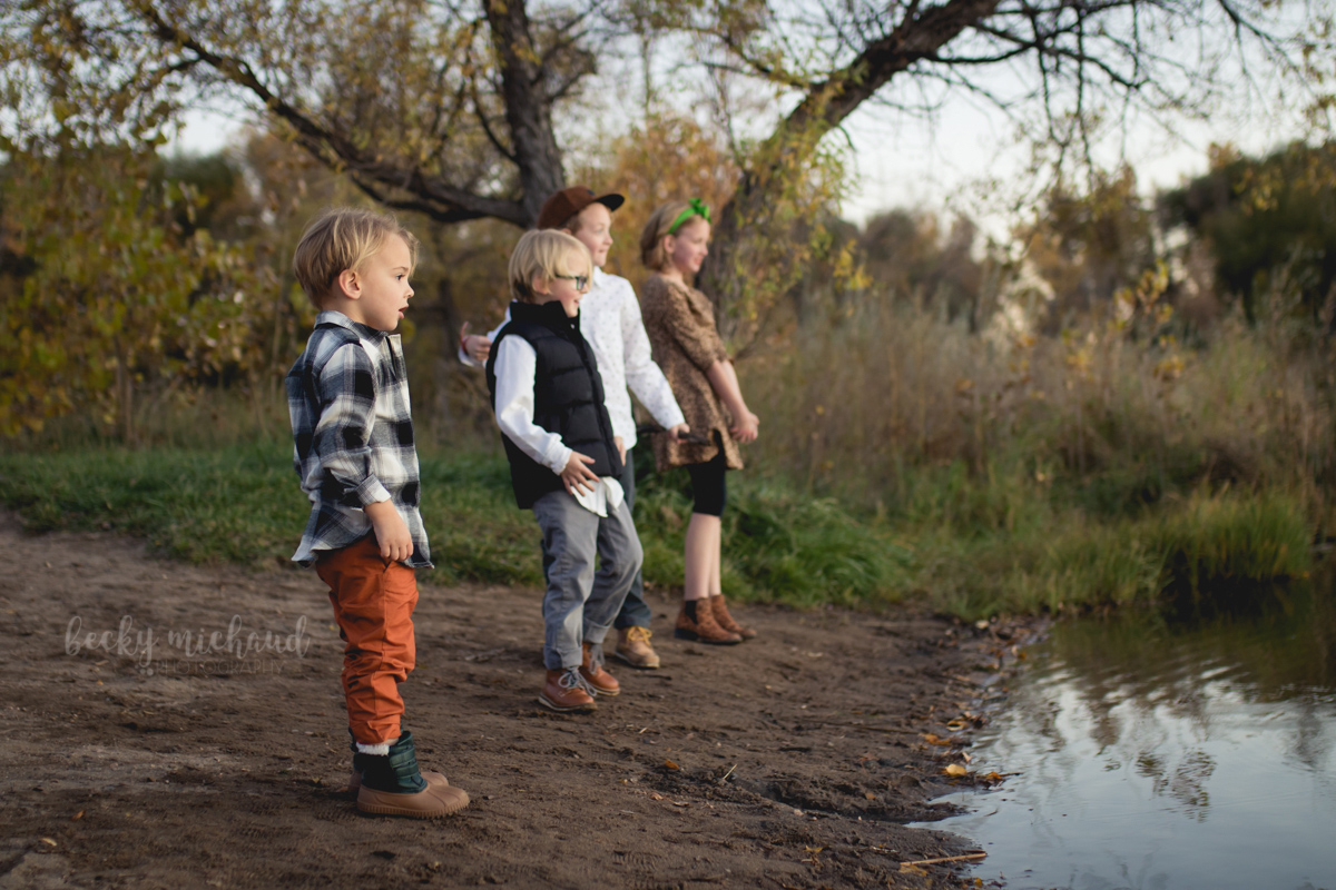 Kids throw rocks into a pond in northern Colorado
