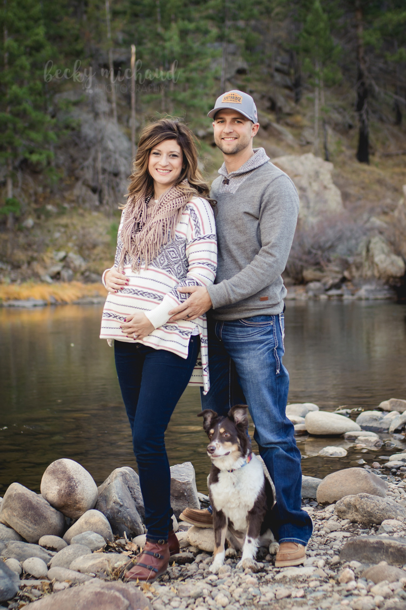Maternity photo of a couple with their dog at Picnic Rock in Fort Collins, CO