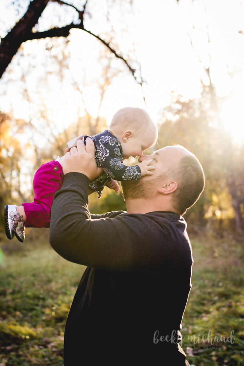 A dad plays with his baby girl during their Fort Collins family photo session