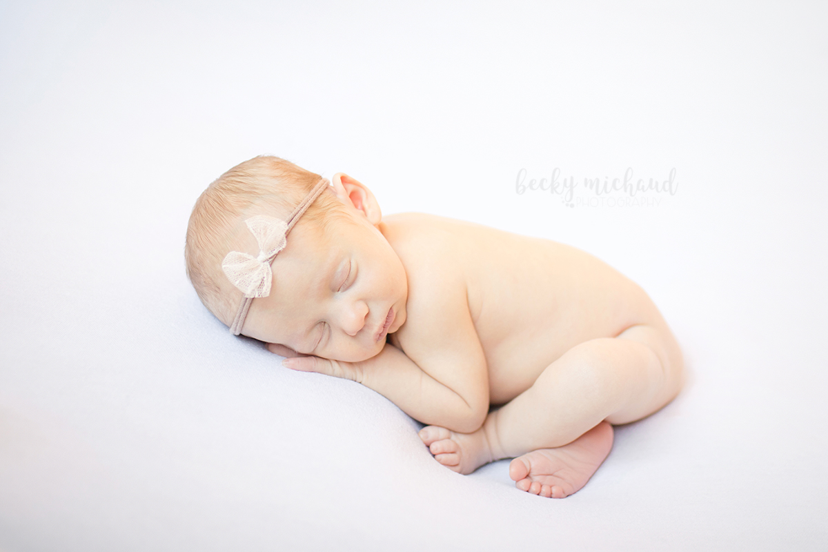 simple minimalist newborn portrait in Fort Collins, Colorado of a baby girl on a white backdrop