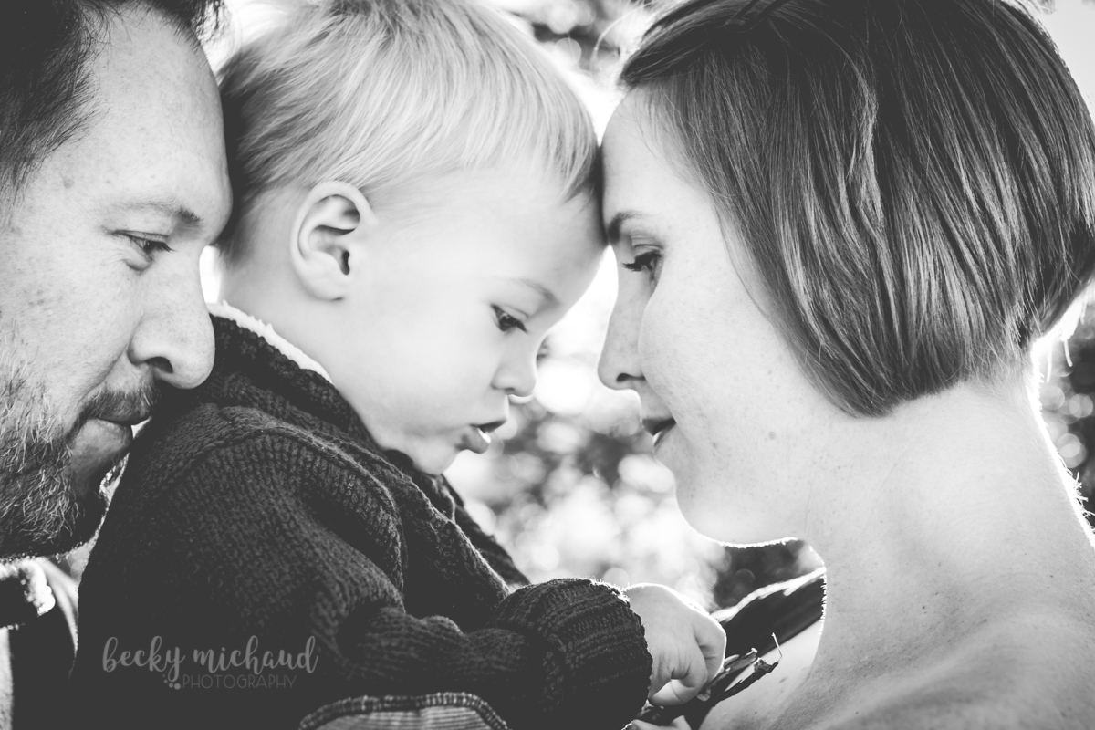 black and white portrait of parents with their little boy