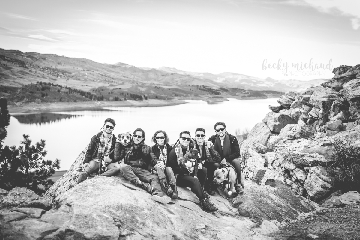 Black and white portrait of a family sitting on the rocks at Horsetooth Reservoir