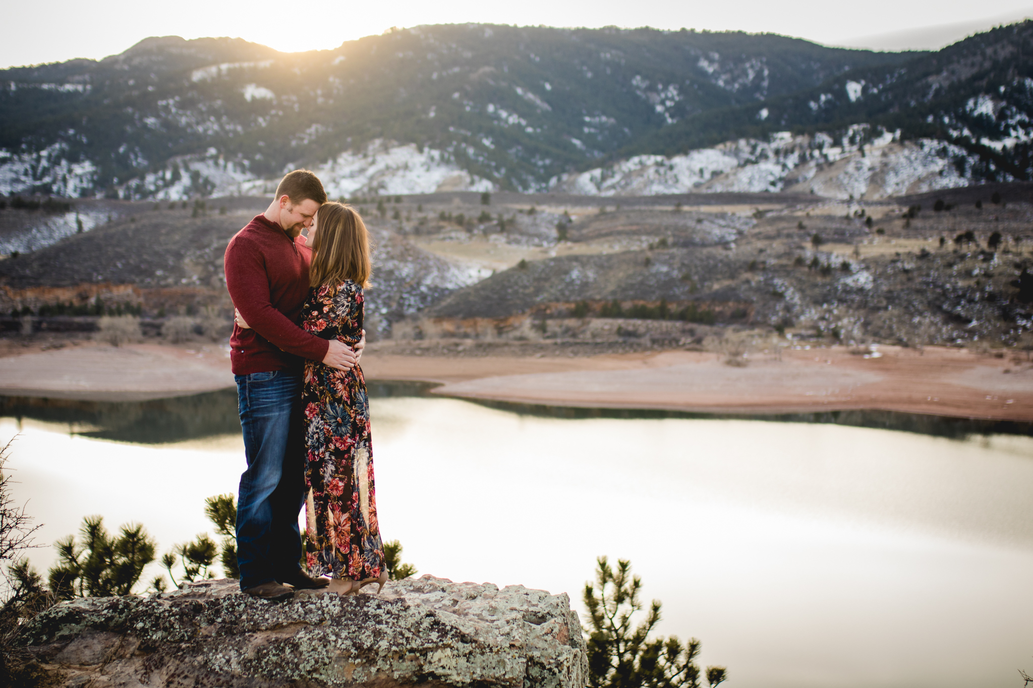 A couple embraces as the sun sets over Horsetooth Reservoir in Fort Collins