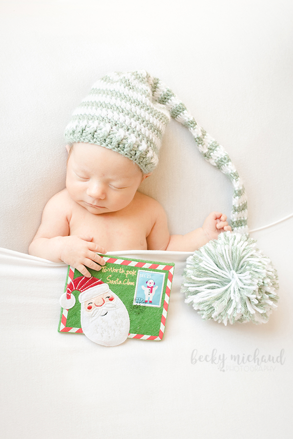 Christmas set up from a Colorado newborn photo session of a baby wearing an elf hat and holding a letter to Santa
