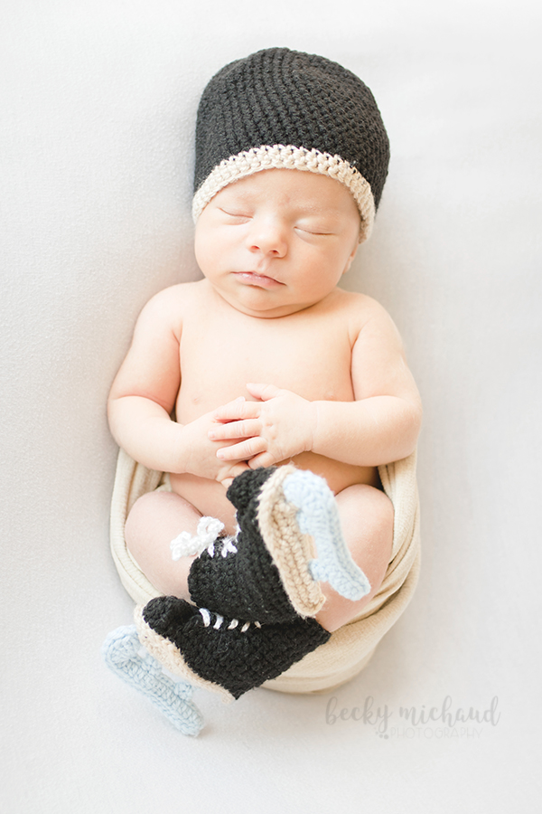 Newborn boy wearing honkey skate booties