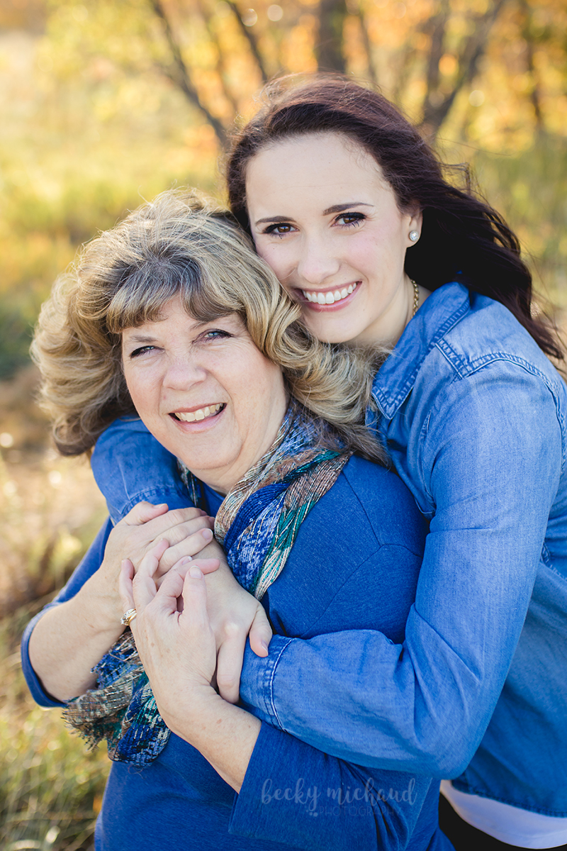 A mother and daughter embrace during their fall family photo shoot in Fort Collins