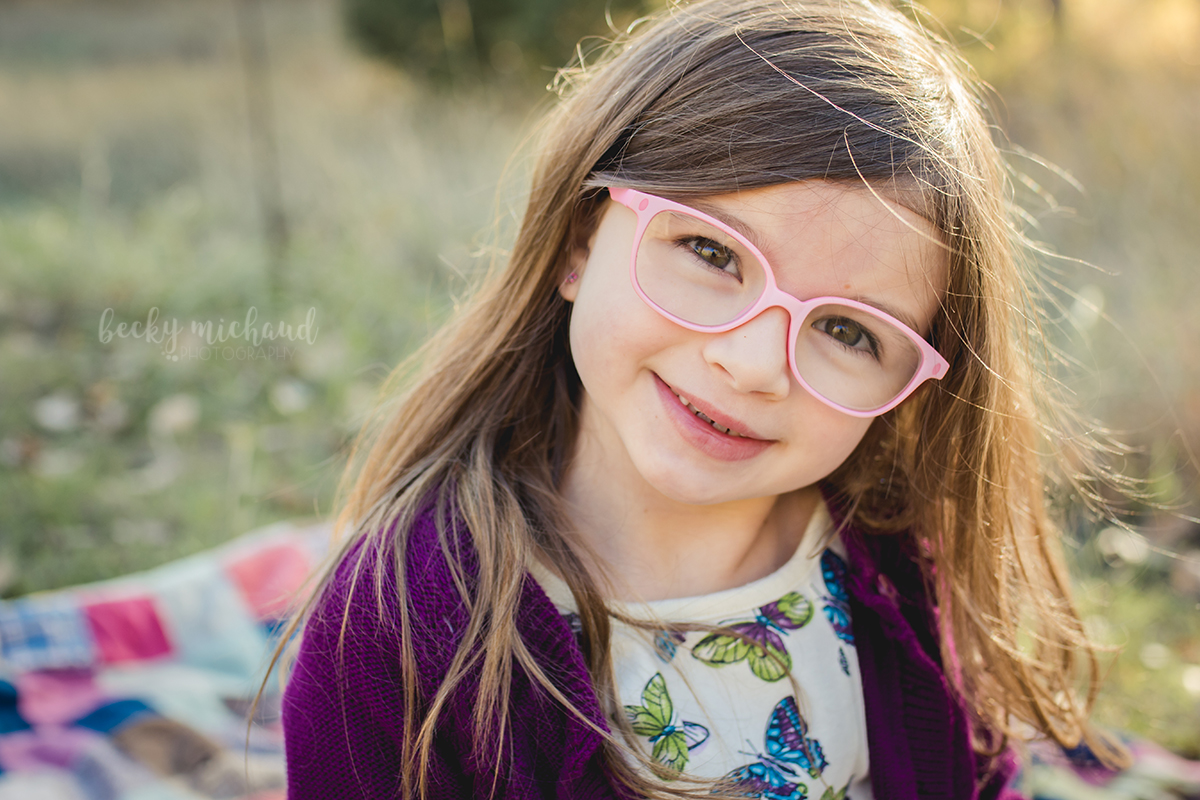 Portrait of a cute little girl with pink glasses by Becky Michaud, Fort Collins Photographer