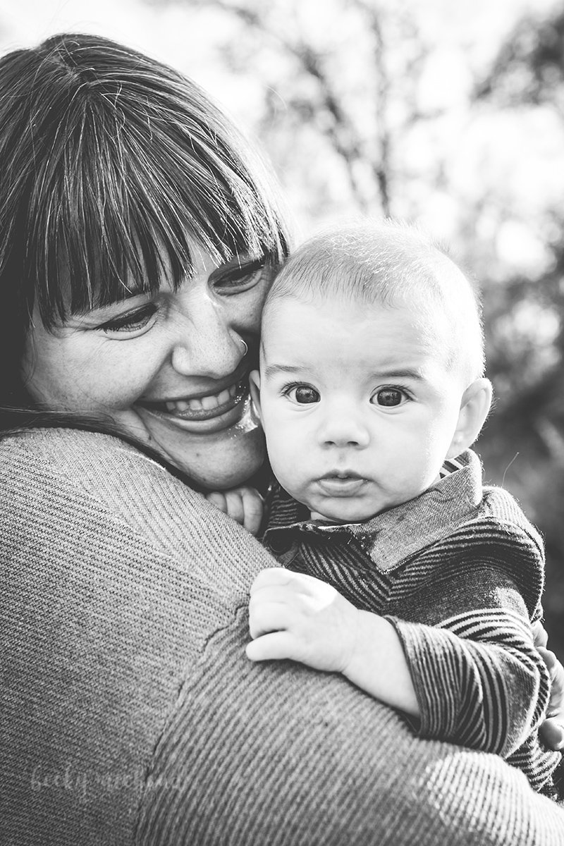 A mom snuggles her baby during their family photography shoot