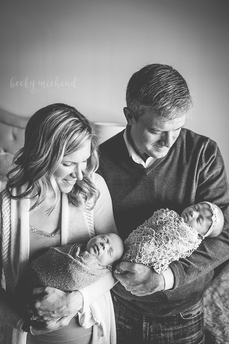 Black and white photos of parents holding their twin babies in their Timnath Colorado home