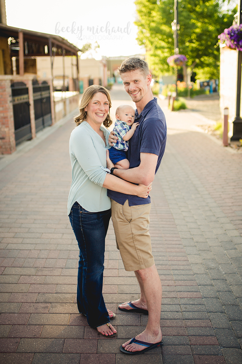 Alleys in Old Town Fort Collins make a great spot for family photos for this couple and their baby
