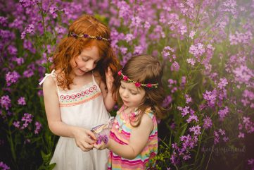 Two sisters pick purple flowers together at the Poudre Environmental Learning Center