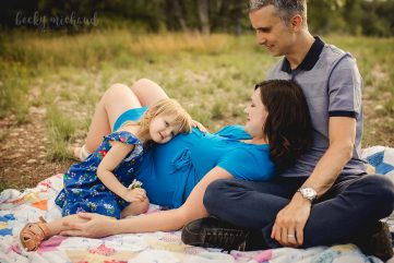 maternity photo of a family reclining on a blanket together at a Fort Collins Natural Area