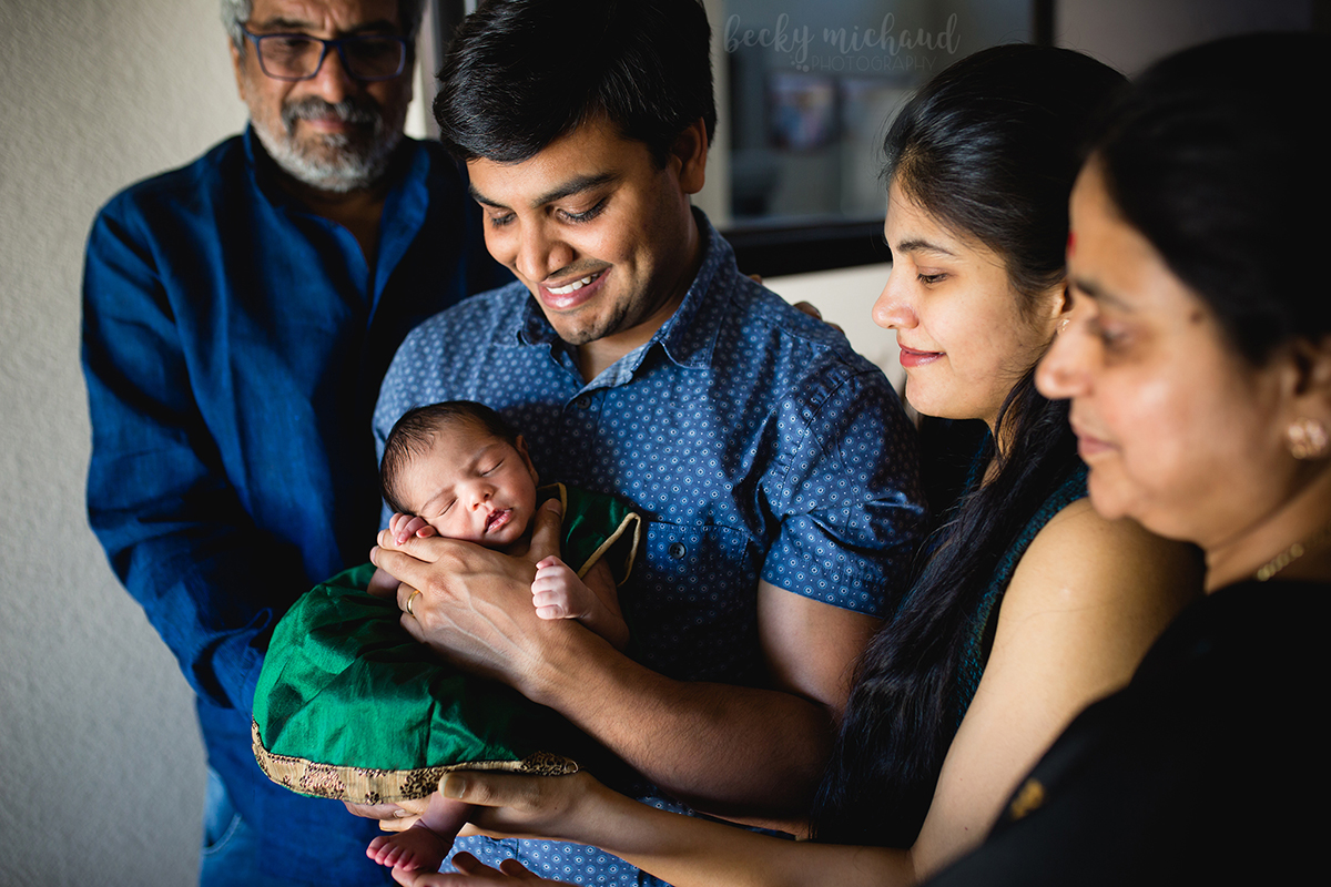 Parents and grandparents smile at the new addition to their family in their Fort Collins home