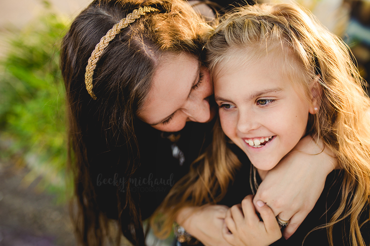 A mom snuggles in close with her daughter on a sunny evening in Northern Colorado 