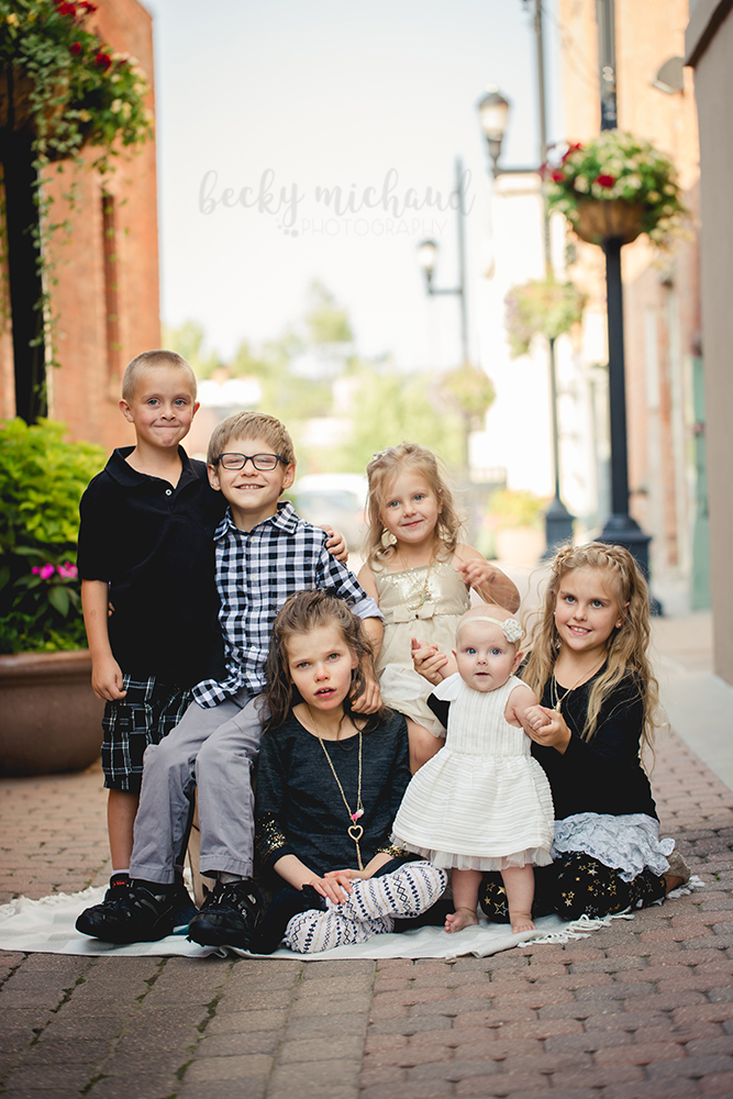 6 siblings sit together for their Old Town Fort Collins family portrait session