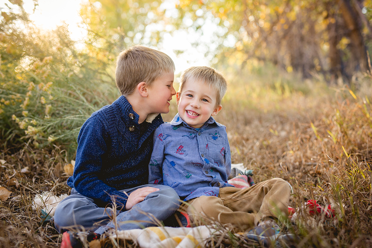Two brothers share a secret during their Fort Collins family photo session