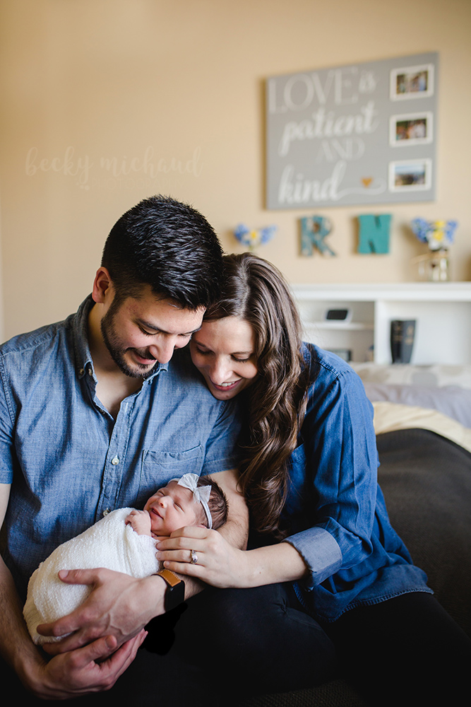 Newborn photographer, Becky Michaud, took this photo of a family of three