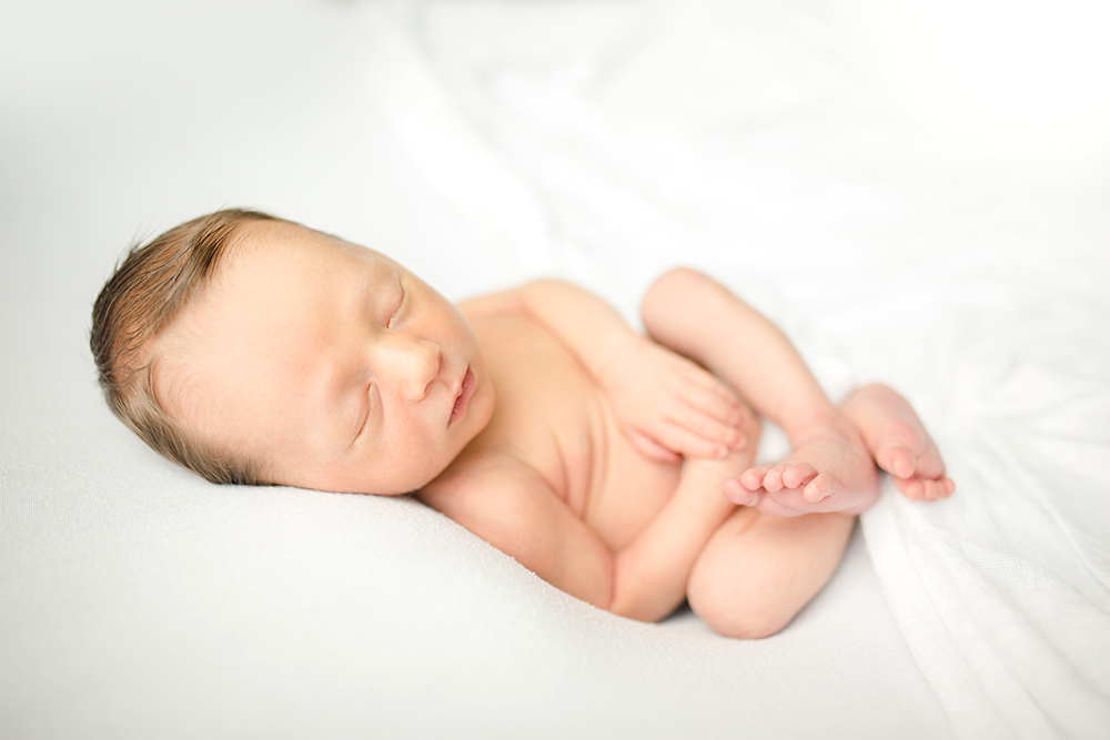 simple newborn photo of a baby boy on a white blanket taken by Becky Michaud, Fort Collins newborn photographer