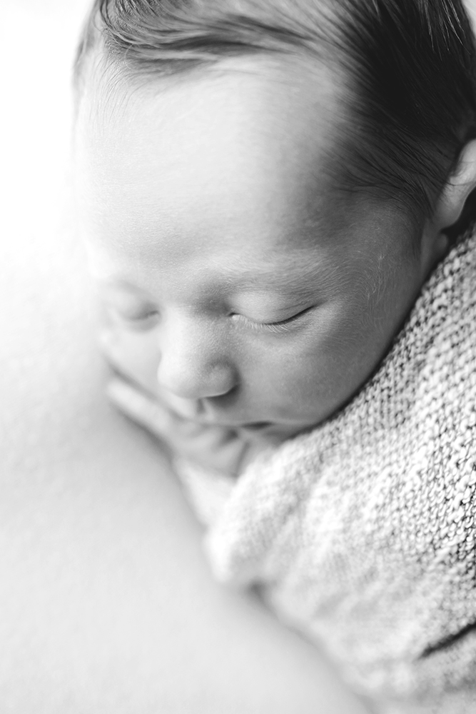 black and white photo of a newborn profile