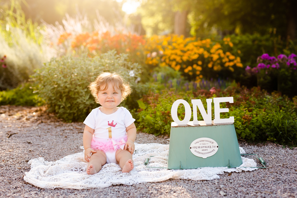 A little girl poses for her one year photo session in Fort Collins, Colorado